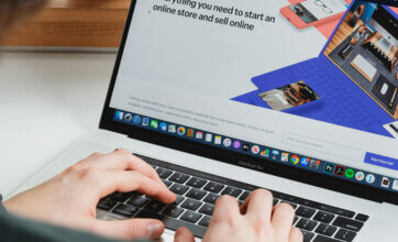 A person setting up a Shopify website on a laptop computer